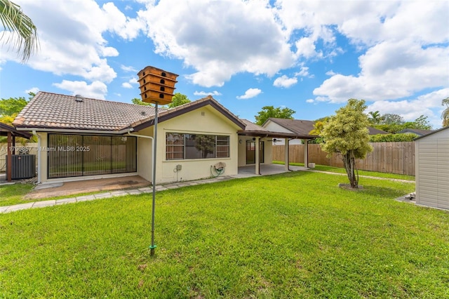 9130 SW 101st Ave, Miami, FL 33176 - rear view of house with fence, central air condition unit, a yard, and a patio area