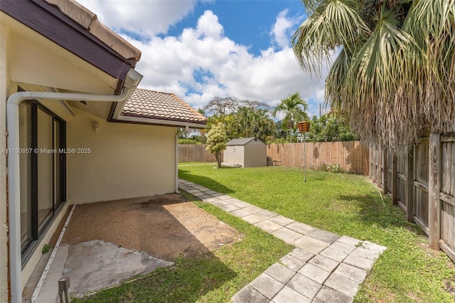view of yard featuring an outdoor structure, a patio, a storage unit, and a fenced backyard
