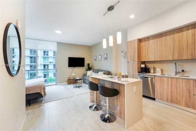 3900 Biscayne Blvd Unit N-821, Miami, FL 33137 - kitchen with a center island, stainless steel dishwasher, modern cabinets, a kitchen bar, and light countertops