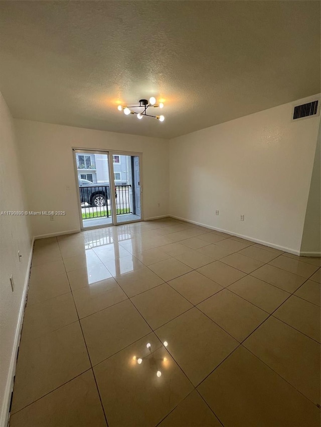 15422 SW 284th St Unit 7104, Homestead, FL 33033 - empty room featuring light tile patterned flooring and a textured ceiling