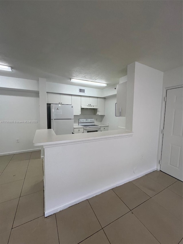 15422 SW 284th St Unit 7104, Homestead, FL 33033 - kitchen with white appliances, tile patterned floors, white cabinets, and light countertops