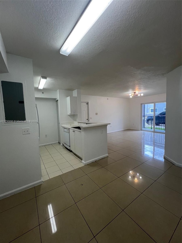 15422 SW 284th St Unit 7104, Homestead, FL 33033 - kitchen with a textured ceiling, white dishwasher, open floor plan, light tile patterned flooring, and white cabinets