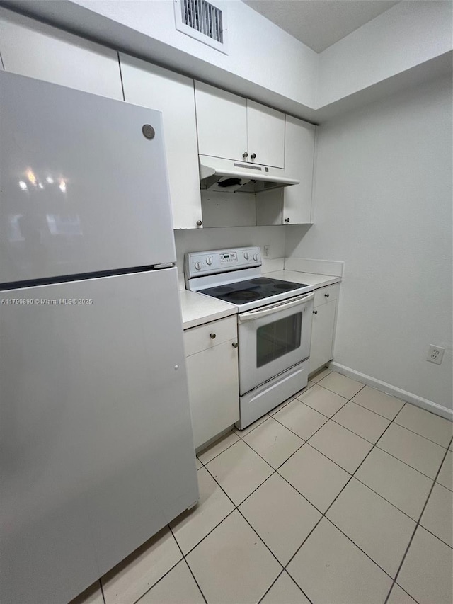 15422 SW 284th St Unit 7104, Homestead, FL 33033 - kitchen featuring white electric stove, freestanding refrigerator, under cabinet range hood, white cabinets, and light countertops