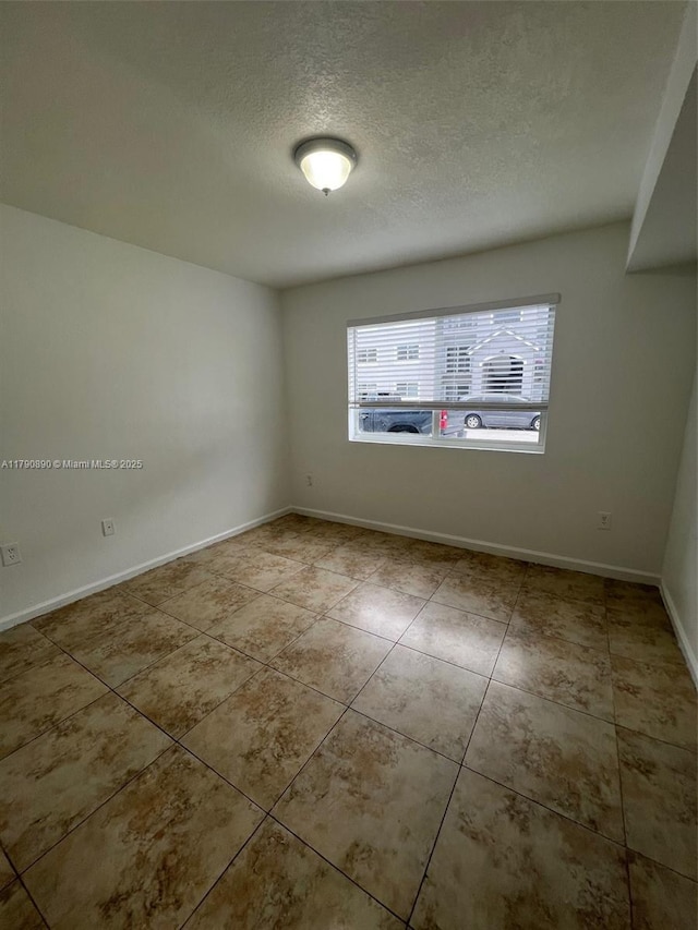 15422 SW 284th St Unit 7104, Homestead, FL 33033 - spare room with a textured ceiling and tile patterned floors