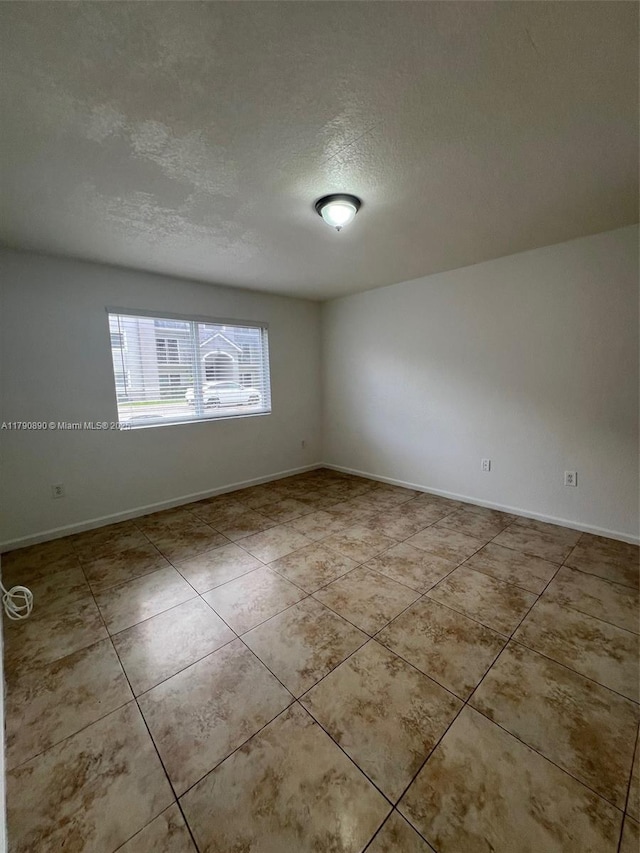 15422 SW 284th St Unit 7104, Homestead, FL 33033 - empty room featuring a textured ceiling and tile patterned flooring