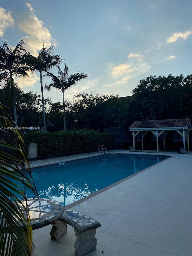 community pool featuring a patio and a gazebo