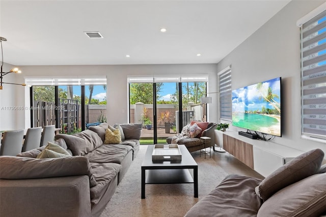 living room featuring a chandelier, visible vents, recessed lighting, and plenty of natural light