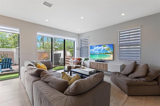 living room with light tile patterned floors, visible vents, and recessed lighting