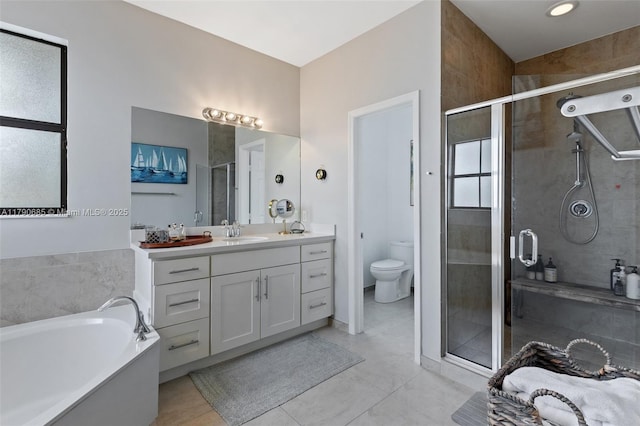 full bath with vanity, a shower stall, and a garden tub