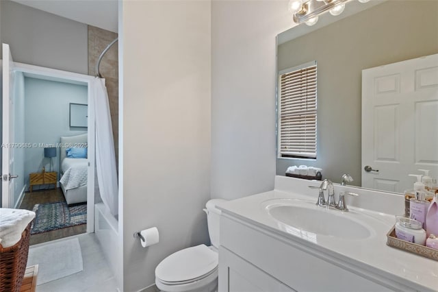 full bathroom with toilet, tile patterned floors, and vanity