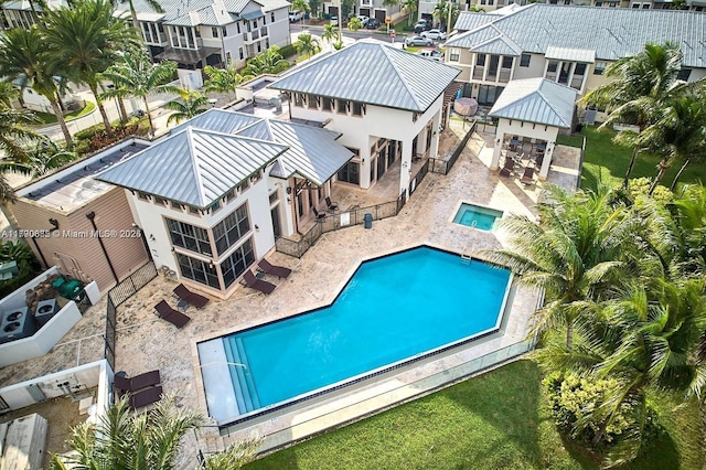 community pool featuring a patio area, a residential view, and a fenced backyard