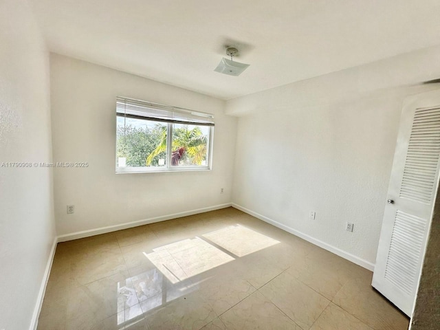 spare room with baseboards