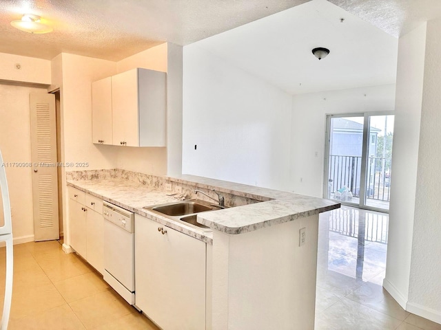 kitchen with light tile patterned floors, light countertops, white dishwasher, baseboards, and a peninsula