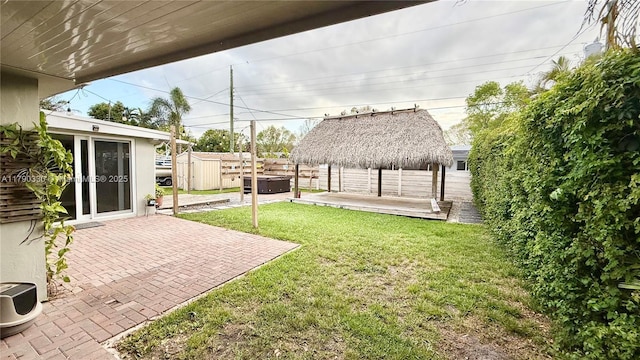 view of yard with an outdoor structure, a gazebo, a hot tub, a storage shed, and a patio area