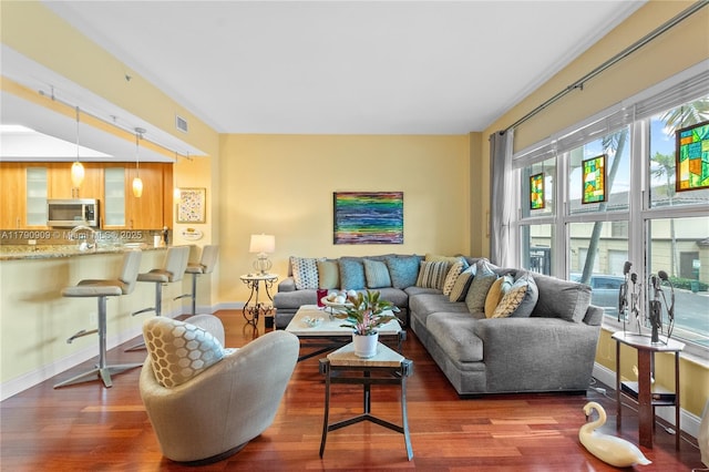living area featuring baseboards and wood finished floors