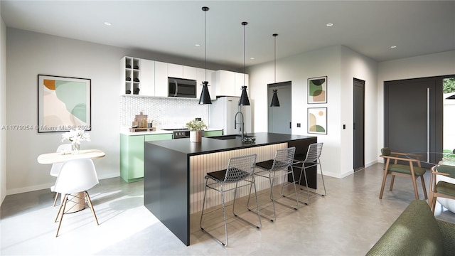 357 Smallwood Unit 1, Port St Lucie, FL 34982 - kitchen featuring stainless steel microwave, a sink, tasteful backsplash, baseboards, and finished concrete floors