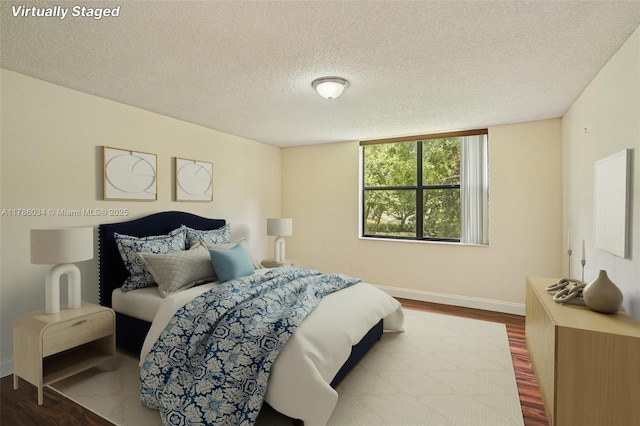 3100 NW 42nd Ave Unit D202, Coconut Creek, FL 33066 - bedroom featuring dark wood-style floors and a textured ceiling