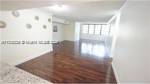 3100 NW 42nd Ave Unit D202, Coconut Creek, FL 33066 - unfurnished room featuring wood finished floors, crown molding, an AC wall unit, and baseboards