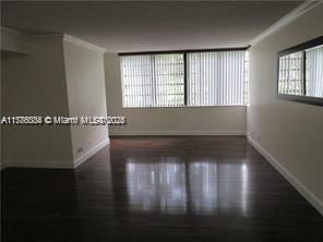 3100 NW 42nd Ave Unit D202, Coconut Creek, FL 33066 - unfurnished room featuring wood finished floors and baseboards