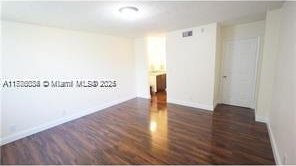 3100 NW 42nd Ave Unit D202, Coconut Creek, FL 33066 - spare room with baseboards and wood finished floors