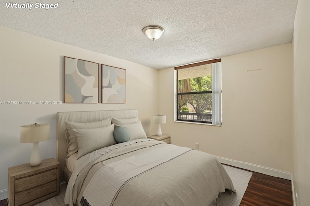 3100 NW 42nd Ave Unit D202, Coconut Creek, FL 33066 - bedroom featuring wood finished floors and a textured ceiling