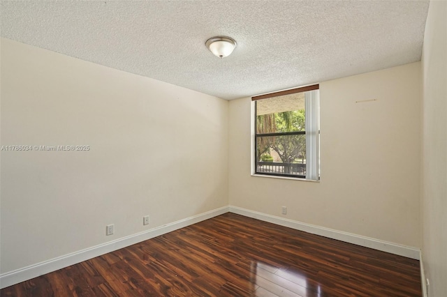 3100 NW 42nd Ave Unit D202, Coconut Creek, FL 33066 - spare room featuring dark wood finished floors and a textured ceiling