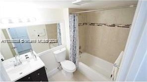 3100 NW 42nd Ave Unit D202, Coconut Creek, FL 33066 - full bath featuring shower / bathtub combination with curtain, vanity, and toilet
