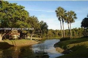 3100 NW 42nd Ave Unit D202, Coconut Creek, FL 33066 - view of water feature with a view of trees