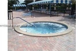 3100 NW 42nd Ave Unit D202, Coconut Creek, FL 33066 - view of swimming pool featuring a community hot tub
