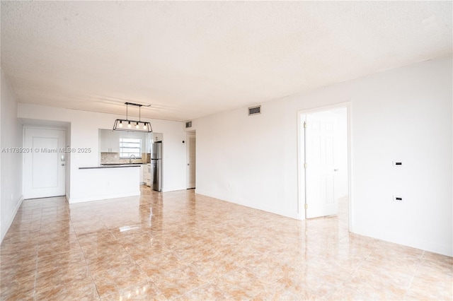 7850 Byron Ave Unit 207, Miami Beach, FL 33141 - unfurnished living room with a textured ceiling