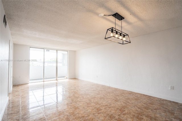 7850 Byron Ave Unit 207, Miami Beach, FL 33141 - empty room with a textured ceiling, baseboards, and light tile patterned floors