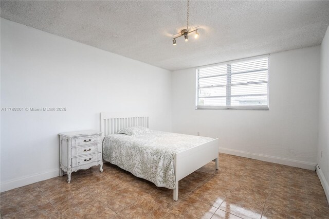 7850 Byron Ave Unit 207, Miami Beach, FL 33141 - bedroom with a textured ceiling and baseboards