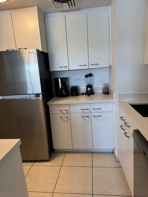 2451 Brickell Ave Unit 4P, Miami, FL 33129 - kitchen with freestanding refrigerator, dishwasher, light countertops, and white cabinets