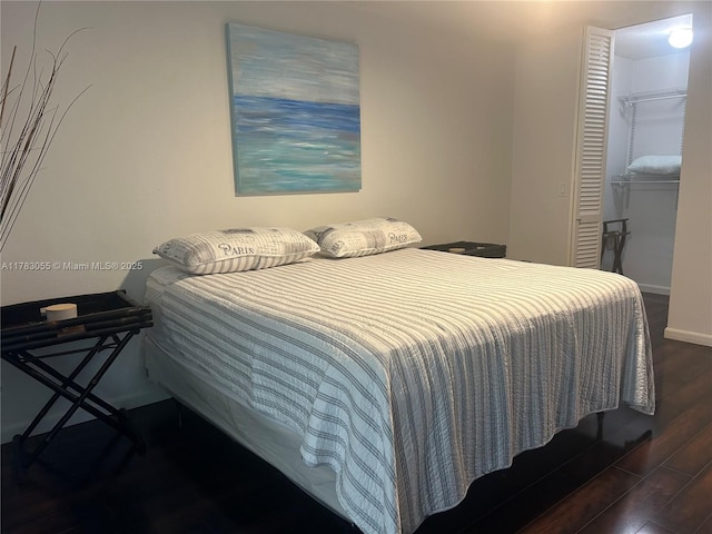 2451 Brickell Ave Unit 4P, Miami, FL 33129 - bedroom with wood finished floors, a closet, a spacious closet, and baseboards