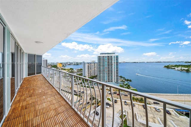 balcony featuring a view of city and a water view
