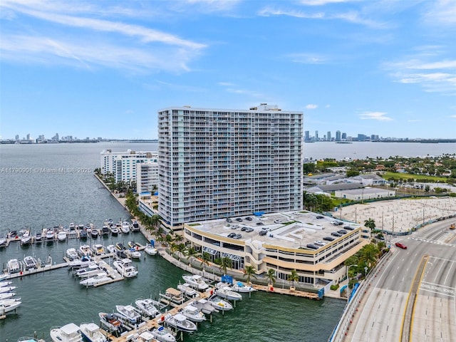 birds eye view of property with a water view and a city view