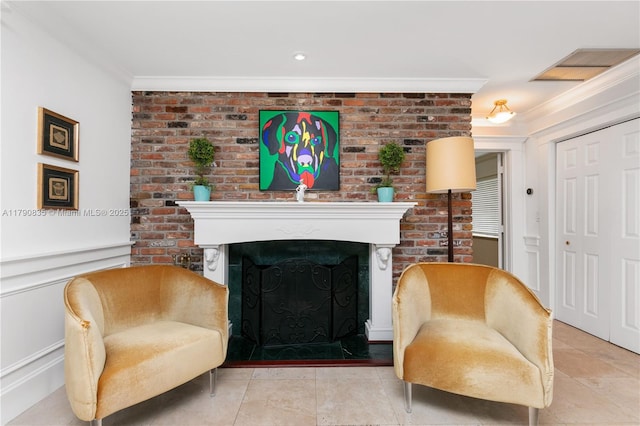living area with tile patterned floors, ornamental molding, a fireplace, and brick wall