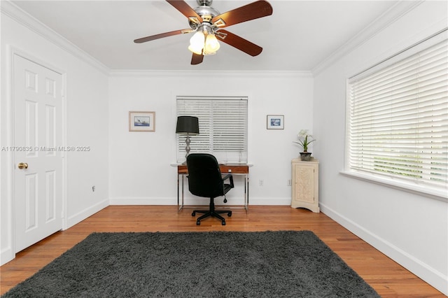 office area featuring baseboards, ornamental molding, a ceiling fan, and wood finished floors