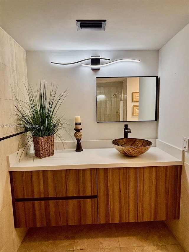 bathroom with visible vents, tile patterned flooring, and vanity