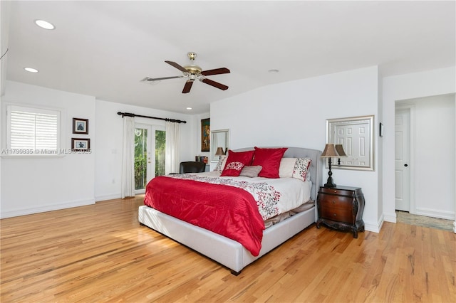 bedroom with light wood-style floors, baseboards, and access to exterior