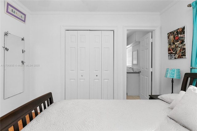 bedroom with crown molding, connected bathroom, and a closet