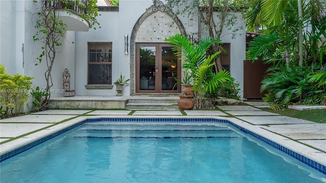 outdoor pool featuring french doors