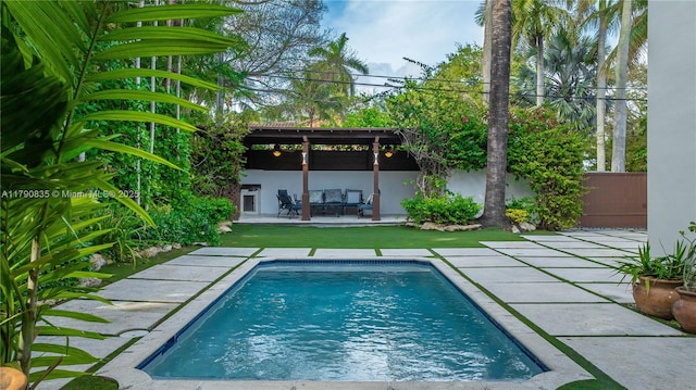 view of swimming pool featuring a fenced in pool and a patio area