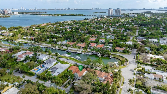 drone / aerial view featuring a water view, a city view, and a residential view