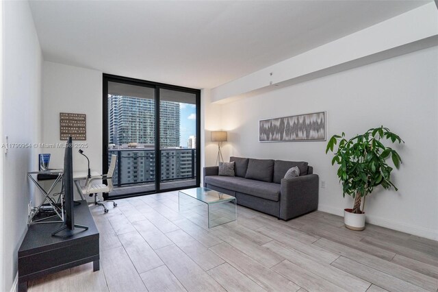45 SW 9th St Unit 1205, Miami, FL 33130 - living room featuring a wall of windows, light wood finished floors, and a view of city