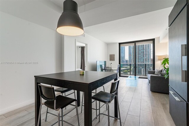 45 SW 9th St Unit 1205, Miami, FL 33130 - dining space with floor to ceiling windows and light wood-style flooring
