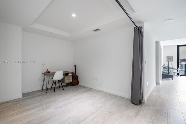 45 SW 9th St Unit 1205, Miami, FL 33130 - unfurnished room with wood finished floors, a tray ceiling, an office area, and recessed lighting