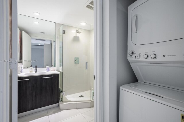 45 SW 9th St Unit 1205, Miami, FL 33130 - full bathroom with stacked washer and clothes dryer, vanity, a shower stall, and tile patterned flooring