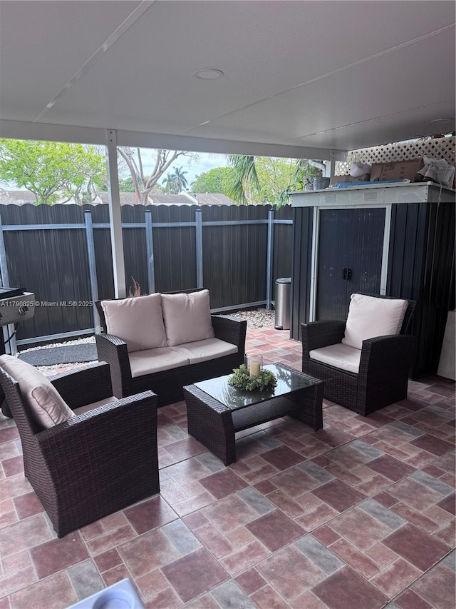 view of patio with an outdoor living space and fence