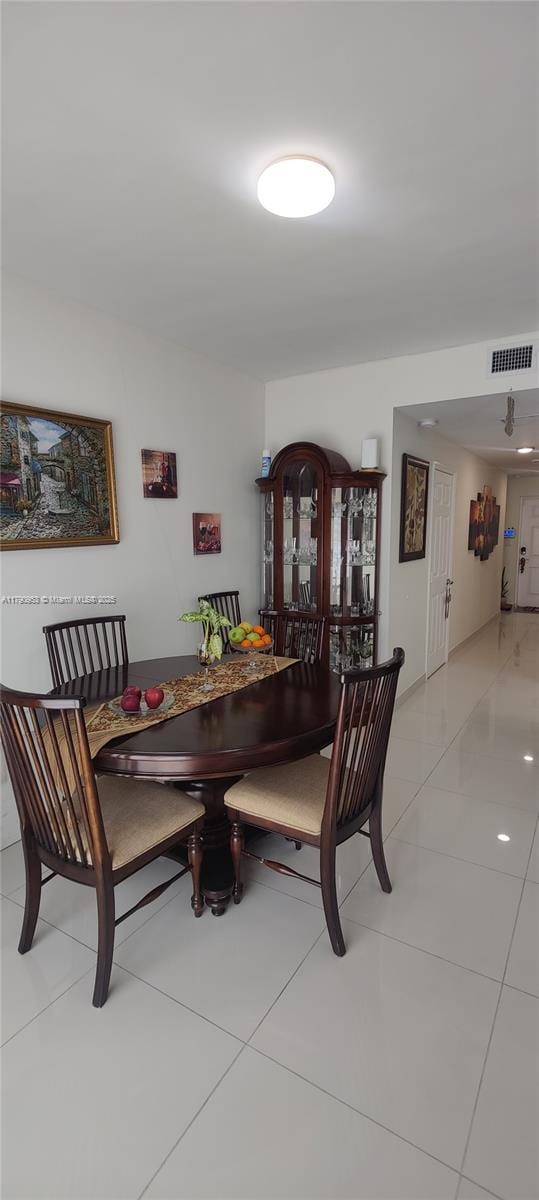 dining space with visible vents and light tile patterned floors